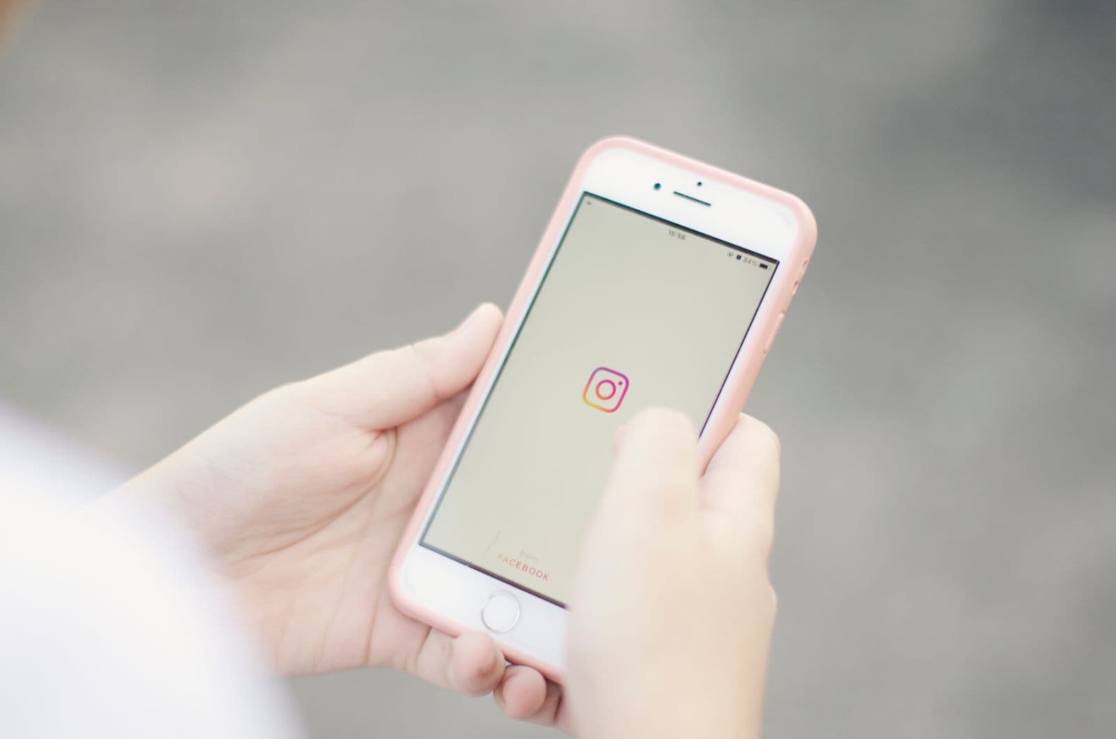 Hands holding a smartphone with the Instagram app open