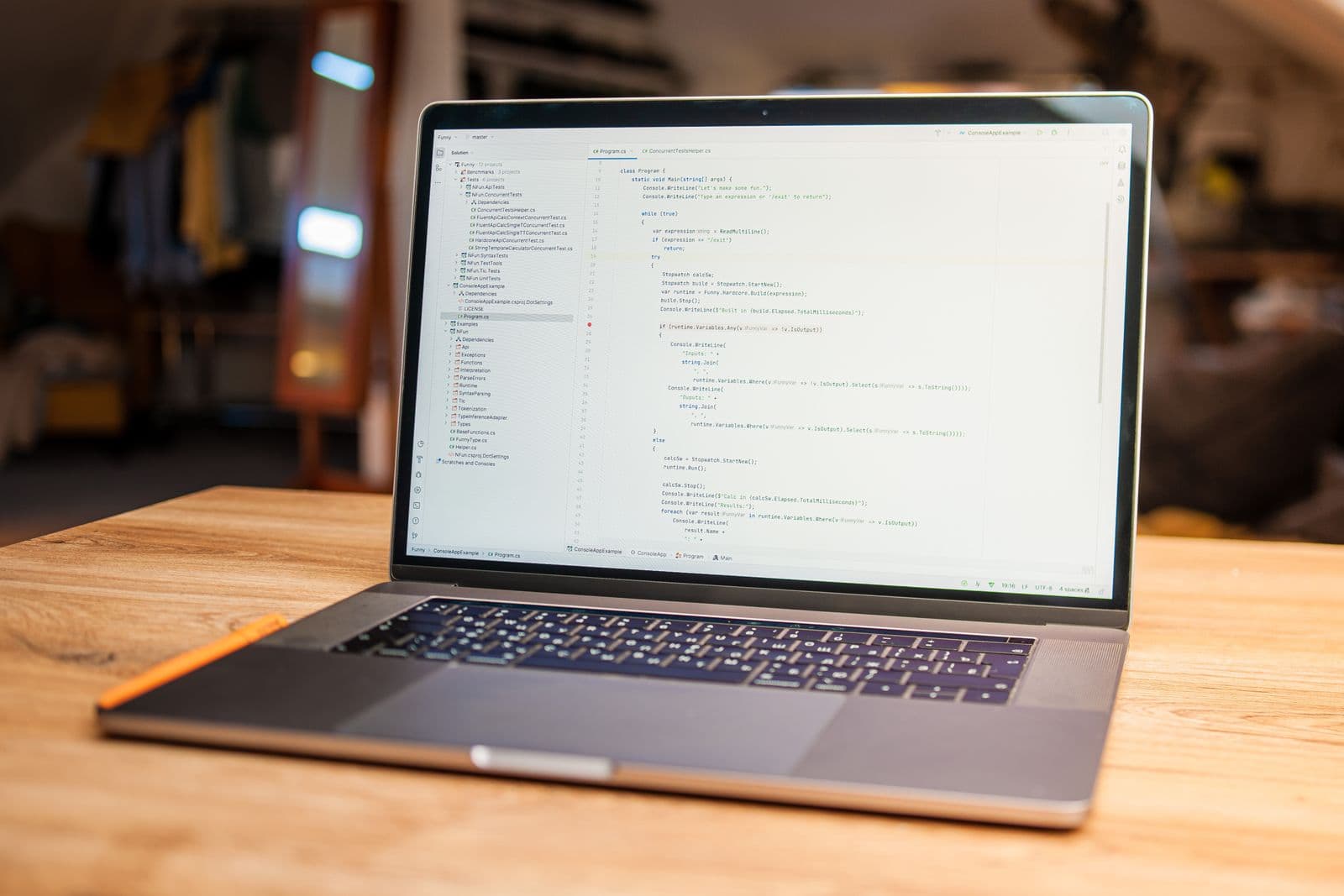 Open laptop displaying code on a wooden desk