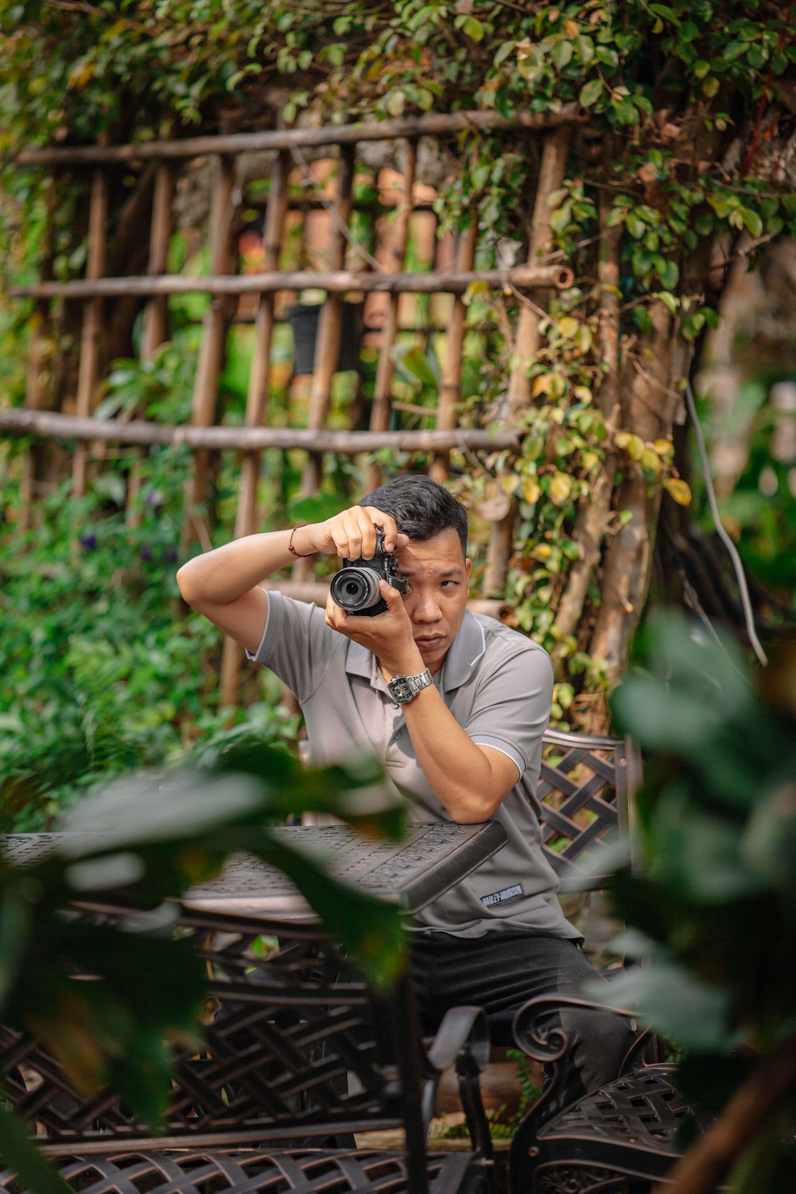 Photographer taking pictures outdoors in a lush green setting