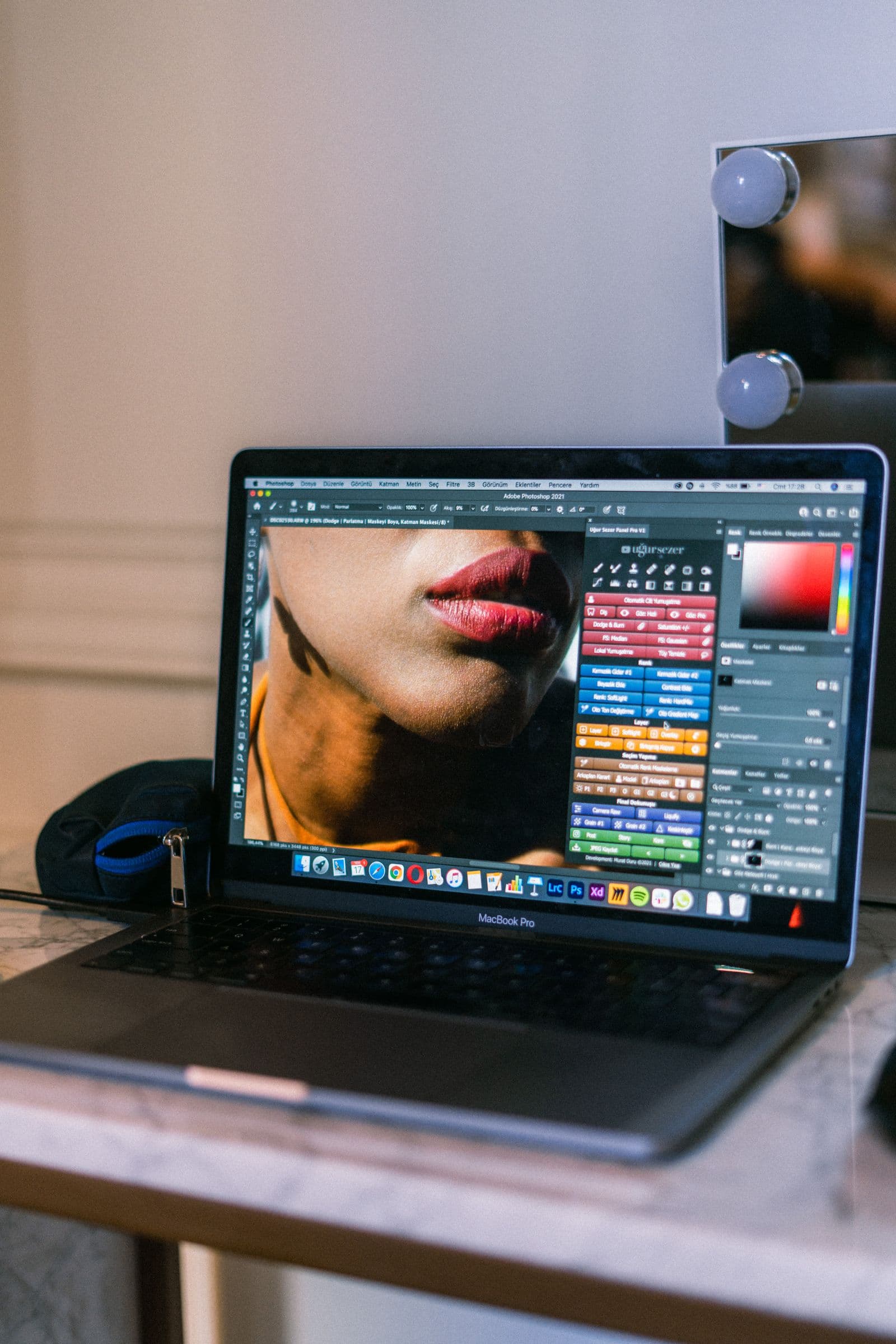 Laptop screen showing photo editing software in a bright workspace