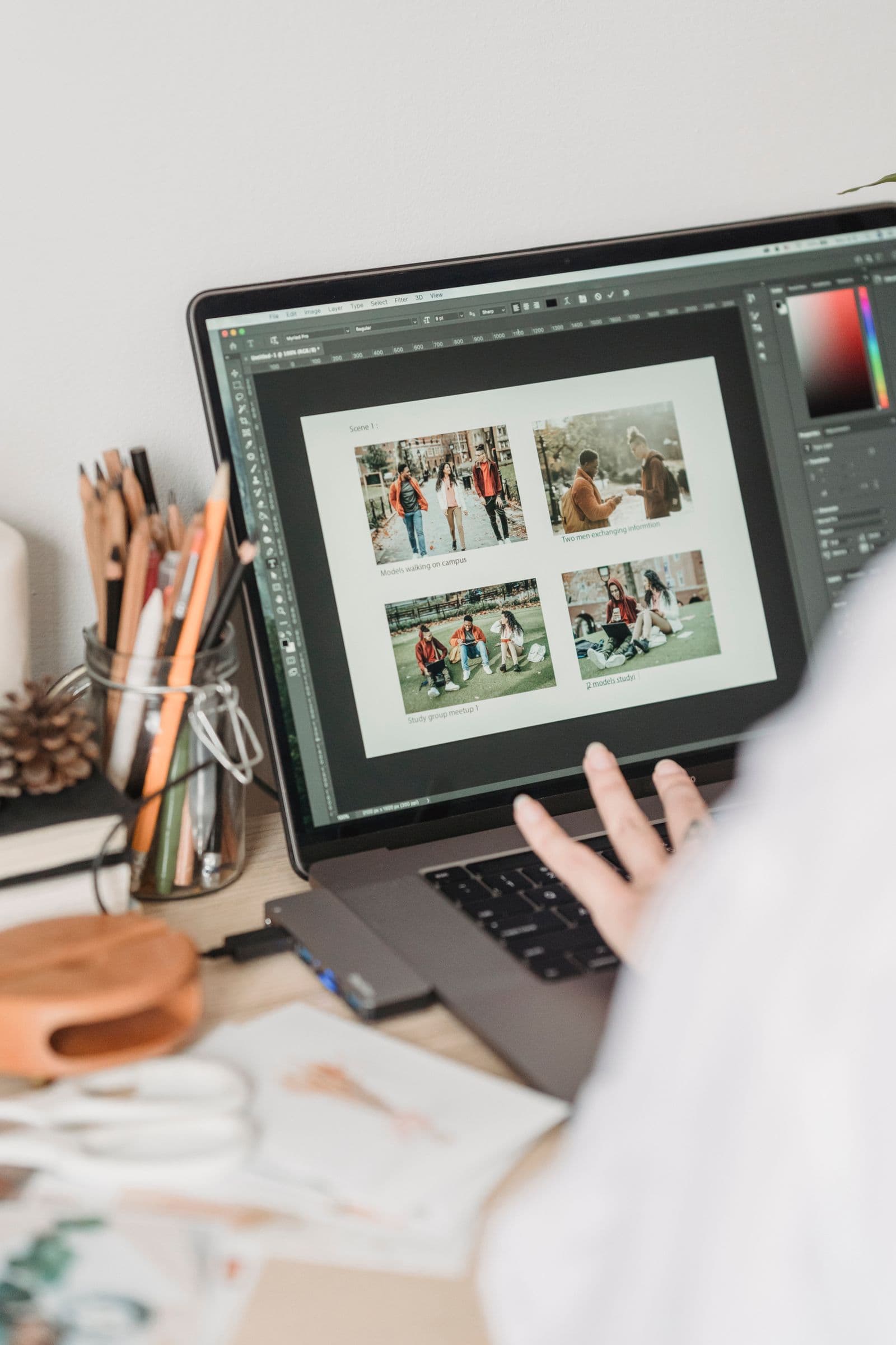 Woman retouching photos on a laptop at a home desk
