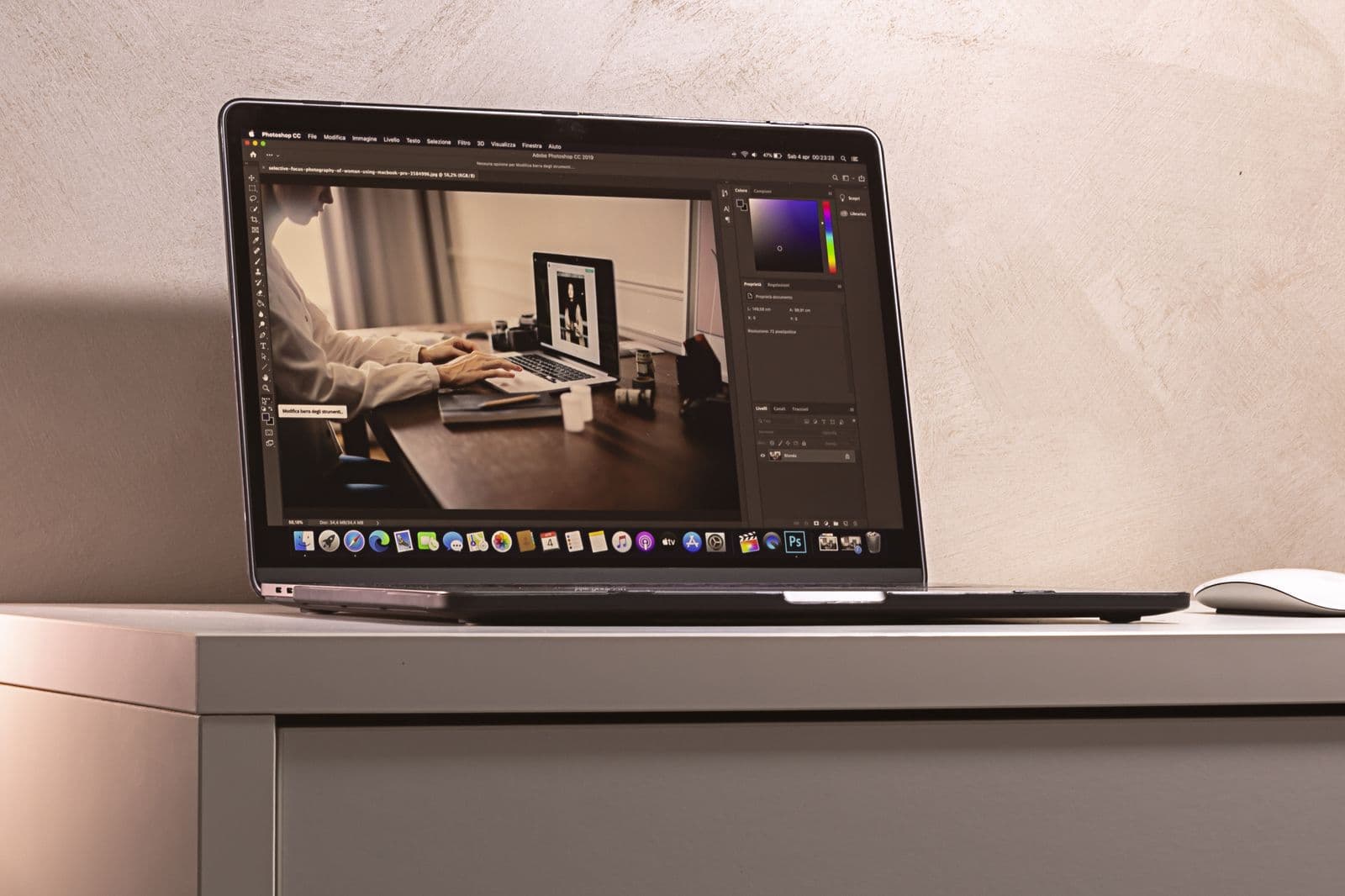 Laptop displaying photo editing software on a clean desk