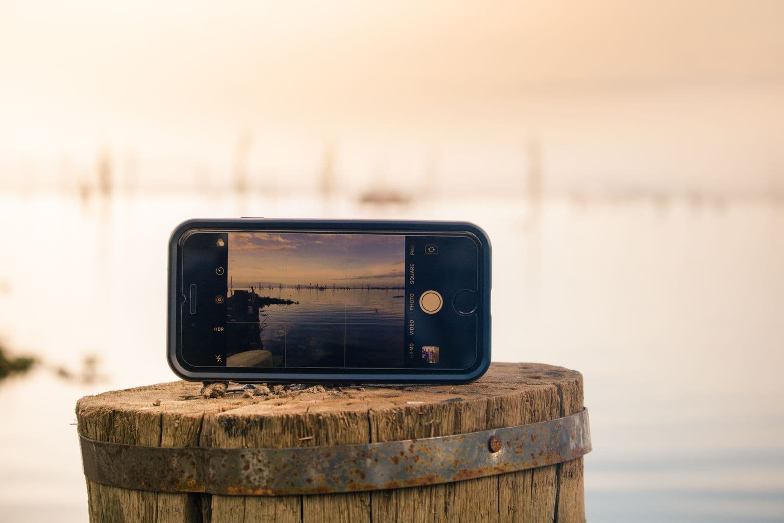 Close-up of an iPhone screen displaying a lake photo